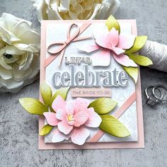 a close up of a card with flowers and scissors