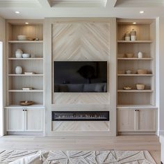 a living room filled with furniture and a flat screen tv on top of a wooden shelf