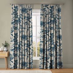 a blue and white curtain hanging in front of a window