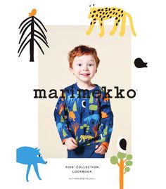 a young boy wearing a blue shirt with giraffes on it