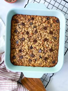 a blue baking dish filled with granola and chocolate chips