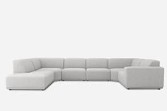 a white sectional couch sitting on top of a white floor