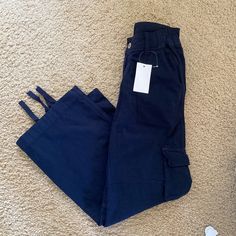 Relaxed, Straight-Leg Cargo Pants With 6 Pockets, Adjustable Elastic Bands At The Waist And Lace Adjusters To The Cuff Of Each Leg. Fabrics: 100% Cotton Measurements: 9"(23 Cm) Rise, 30"(77 Cm) Inseam, 26"(66 Cm) Waist( Stretches) Made In: China Navy Wide Leg Cotton Pants, Navy Wide Leg Casual Cargo Pants, Navy Wide Leg Pants With Belt Loops, Mid-rise Blue Cargo Pants With Pockets, Casual Navy Straight Leg Cargo Pants, Blue Mid-rise Cargo Pants With Pockets, Blue Full-length Parachute Pants, Navy Wide Leg Cargo Pants With Pockets, Casual Navy Straight Leg Bottoms