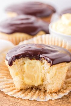 cupcakes with chocolate frosting and peanut butter on top sitting on a wooden board