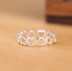 Silver Adjustable Heart Ring Perfect gift for someone special or yourself. Features: -925 silver stamped ring -Adjustable -Heart Height approximately 4mm Silver Maintenace: -Avoid direct contact with perfume and water -Clean with a soft clothe -Keep away from chemicals Follow us on FB and IG for new releases and give aways. Checkout our shop for similar items. Heart Eternity Ring, Heart Promise Rings, Heart Rings, Open Rings, Silver Heart Ring, Hollow Heart, Linking Rings, Wedding Accessories Jewelry, Silver Band Ring