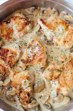 chicken with mushrooms and gravy in a pan