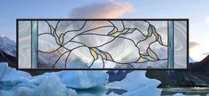 a stained glass window sitting on top of icebergs in the snow covered mountains