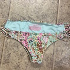 Never Worn. Strappy Victoria Secret Cheeky Bikini Swim Bottoms. Pink Teal Gold Green Pink Printed Bottoms For Beach Party, Printed Pink Bottoms For Beach Party, Pink Beachy Bottoms For Beach Party, Pink Printed Bottoms For Beach Season, Beachy Pink Bottoms For Sunbathing, Pink Tie-side Bottoms For Beach Party, Victoria's Secret Bottoms For Beach Party, Trendy Pink Bottoms For Pool, Victoria's Secret Bottoms For Sunbathing In Summer