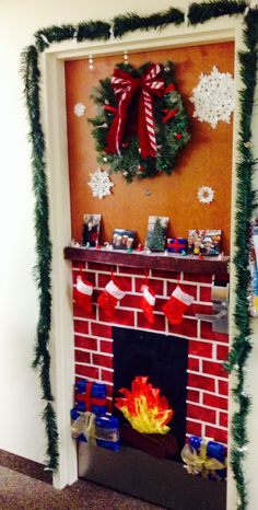 a fireplace decorated for christmas with decorations on the mantle