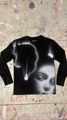 a black shirt with an image of a woman's face on it