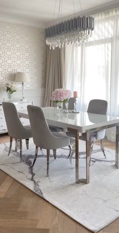 a dining room table with chairs and a chandelier