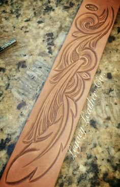 an intricately carved leather tie sitting on top of a counter