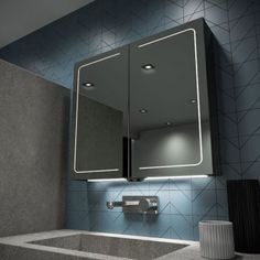 a bathroom with a sink, mirror and lights on the wall above it is shown