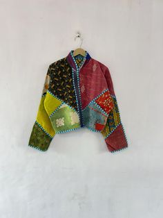 a colorful jacket hanging on a white wall