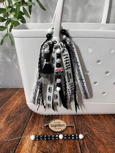 Embrace your role as a devoted band mom with this personalized Band Mom Bag Charm/Tassel. Crafted with attention to detail, this tassel adds a touch of flair to any bag or purse, making a bold statement. With its playful design, it's a stylish way to show off your band mom pride wherever you go. The high-quality materials ensure durability, keeping up with your active lifestyle. Whether you're cheering on the sidelines or running errands, this tassel is a fun and functional addition to your daily essentials. Surprise a fellow band mom with this thoughtful gift that celebrates the bond forged through supporting the team. Elevate your style and show your dedication with this unique and practical Bag Clip Accessory.  If you'd to incorporate your school colors just add your colors to the perso Band Competition Goodie Bags, Color Guard Keychain, Bogg Bag Baseball Charm, Bog Bag Charm, Keychain Music, Mom Bag, Mom Pride, Purse Making, Bogg Bag