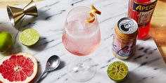 grapefruit, limeade, and an apple cider on a marble table