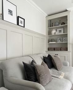 a living room filled with furniture and lots of pillows