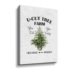 a white canvas with the words u - cut tree farm and a small christmas tree