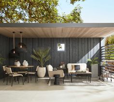 an outdoor living area with furniture and plants