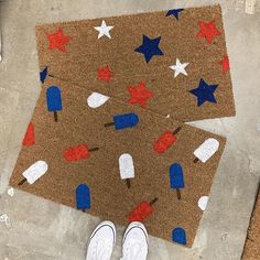 someone is standing in front of a door mat with popsicles and stars on it