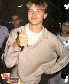 a young man giving the thumbs up sign