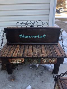 an old bench with the word charlotte painted on it and chains hanging from it's sides