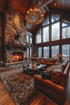 a living room filled with furniture and a fire place in front of a large window