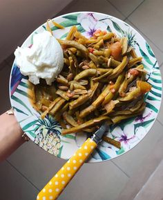 a white plate topped with green beans and whipped cream