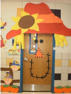 a door decorated to look like a scarecrow with a sunflower on his hat