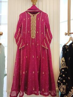 Turned heads in this beautiful fuchsia pink. Hand crafted to perfection. Adorned on pure organza in a flowy gown, with delicate handwork in gotah, dabka, sequins and crystals, paired with straight raw silk trousers and pure organza dupatta. An ideal look for festivities’   Delivery Time: 4 to 8 weeks Pink Raw Silk Anarkali Set With Dabka Work, Pink Tissue Silk Salwar Kameez For Party, Pink Raw Silk Sharara With Dabka Work, Pink Tissue Silk Anarkali Set With Dabka Work, Party Wear Organza Gown With Dabka, Pink Organza Salwar Kameez With Sheer Dupatta, Silk Lehenga With Dabka Work In Pink, Designer Wear Pink Gown With Dabka Work, Pink Lehenga With Dabka Work In Tissue Silk