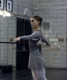 a young woman is practicing her moves on the dance floor