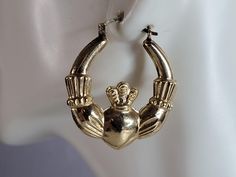 "A PAIR OF WOMENS VINTAGE ESTATE 10K GOLD IRISH CLADDAGH HOOP EARRINGS.  THE EARRINGS WEIGH 5.1g, AND MEASURE  1 1/4\" BY 1 1/8\".   EARRINGS ARE MARKED.   WOULD MAKE A GREAT GIFT FOR THAT SPECIAL SOMEONE. BE SURE TO LOOK AT SOME OF MY OTHER ITEMS FOR SALE.     THANK YOU. IF THERE ARE ANY ISSUES PLEASE CONTACT US, WE'RE ALWAYS HAPPY TO TRY TO HELP YOU OUT AS BEST AS WE CAN." Vintage Yellow Gold Pierced Hoop Earrings, Vintage Small Hoop Earrings, Tarnish Resistant, Vintage Small Hoop Earrings Tarnish Resistant, Vintage 14k Gold Hoop Earrings, Vintage Tarnish Resistant Hoop Earrings, Vintage Gold Hoop Earrings In 14k, Vintage Pierced Hoop Jewelry, Gold Hinged Earrings For Anniversary, Vintage 14k Gold Hoop Earrings For Anniversary