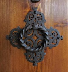 an ornate door handle on a wooden door