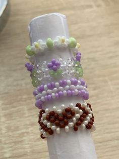 a stack of bracelets sitting on top of a white napkin covered in bead