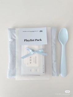 a plastic fork and spoon in a package with the label playlist pack on it