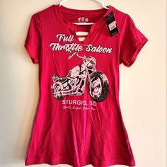 a women's t - shirt with a motorcycle on it hanging from a hanger