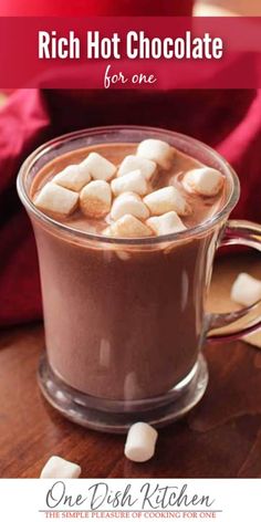 hot chocolate in a glass mug with marshmallows on the side and text overlay that reads rich hot chocolate for one