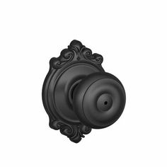 a black door knob with an ornate design on the front and back side, shown against a white background