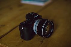 a camera sitting on top of a wooden table