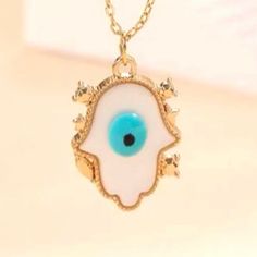 “Hamsa” Hand Blue Evil Eye White Opalescent Gold Star Framed Protection Pray Necklace. Lovely White Hamsa Hand With Blue Evil Eye In The Center. Framed By Tiny Gold Stars & Gemstones. On A Gold Cable Chain. New. *See Also “Evil Eye Butterfly” Listing. Measurements: Pendant Length: 0.8” Pendant Width: 0.6” Chain Length: 16” (+ 3” Extender Chain) If You Want It, Don’t Let It Get Away Send Me An Offer! I Love To Do Bundle Order Discounts! White Bohemian Necklace With Evil Eye, Bohemian White Necklace With Evil Eye Detail, Bohemian White Evil Eye Necklace, Spiritual White Star Necklace, Blue Evil Eye Charm Necklace, White Bohemian Star Jewelry, Bohemian White Star Jewelry, Gold Knot Bracelet, Eye Butterfly