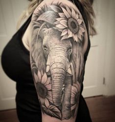 an elephant and sunflowers tattoo on the arm