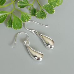 A PAIR of simple curved tear drop shaped sterling silver earrings. Size: Tear drop: 5 x 7 x19 mm Drop length: 30mm Weight: 2.2 gm Price listed is for a PAIR of hoops. These earrings are made of 925 hypoallergenic sterling silver Can be packaged in a gift box. I can include a personal message from you if needed You are welcome to contact me at... bhavnakwintra1956@gmail.com For more beautiful pieces from my shop, please browse 👇 BRACELET https://www.etsy.com/shop/TheSilverGame?ref=seller-platfor White Gold Drop Earrings For Everyday, Minimalist Teardrop Hallmarked Earrings, Minimalist Hallmarked Teardrop Earrings, Nickel Free White Gold Drop Earrings, Nickel-free White Gold Drop Earrings, Hallmarked Drop Earrings, Classic Silver Teardrop Earrings Gift, Sterling Silver White Gold Teardrop Earrings Gift, White Gold Teardrop Earrings In Sterling Silver As Gift