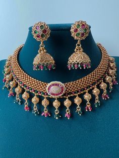 This exquisite piece of craftsmanship comes from our Traditional collection. Finish: 24 grams gold finish Necklace Fastening: Adjustable Dori  Perfect for Indian weddings. Earring jhumka Fastening: Push Back Contains: 1 necklace, 1 pair of earrings Luxury Chandbalis With Intricate Design In Temple Jewelry Style, Luxury Hallmarked Temple Necklace For Diwali, Luxury Bollywood Temple Necklace For Diwali, Luxury Temple Necklace For Festivals And Celebrations, Luxury Temple Jewelry Danglers For Diwali, Luxury Temple Jewelry Danglers For Celebrations, Gold Necklace Indian, South Indian Jewelry, Gold Necklace Set