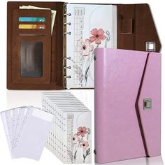 a pink binder, notebooks and several folders are arranged in front of each other