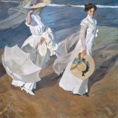 two women in white dresses walking on the beach