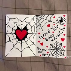 two cards with hearts and spider webs on them