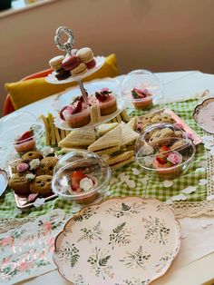 a table topped with plates and cups filled with food