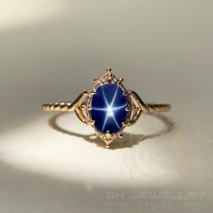 14k Yellow Gold Blue Star Sapphire Ring - Lindy Star Gemstone Jewelry, Perfect Gift for Her ★ Settings ☆ Metal - 925K Sterling Silver ☆ band Color - Rose / White / Yellow ⍟ The ring size shown in the pictures is 8 US. ★ Main Stone ☆ Stone - Lab Created blue star sapphire ☆ Size - 6×8 mm ☆ Shape - Oval ☆ Color Grade- AAA ☆ Certificate of Authenticity and lifetime warranty by Dkjewelrystore ★ Features : ☆ Handmade & Made to order. ☆ Ready to ship in 2-3 Business days. ☆ Complimentary gift wrapping Dark Blue Gemstone Ring, Midnight Blue Star Ring, Sapphire Ring Aesthetic, Fine Jewelry Star-shaped Gemstone, Celestial Star-shaped Gemstone Jewelry, Star-shaped Gemstone Fine Jewelry, Fine Jewelry Star Shaped Gemstone, Star Shaped Gemstone Fine Jewelry, Star Shaped Yellow Gold Gemstone Jewelry