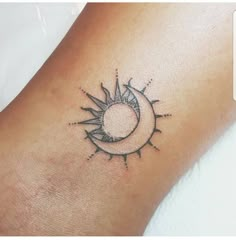 a small sun and moon tattoo on the ankle or foot, done by an artist