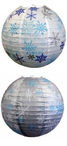 two white and blue paper lanterns with snowflakes on them